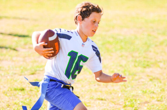 A camper playing football.