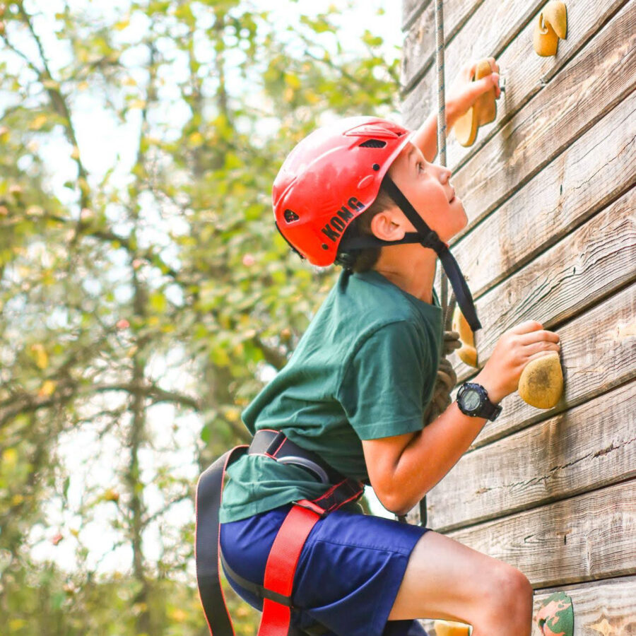 A camper on a climbing wall.
