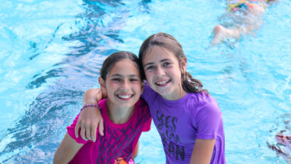 Two campers at a swimming pool.